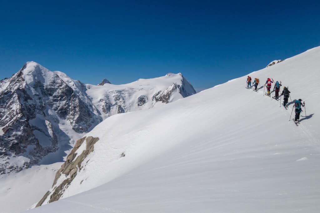 Community mountain climbing in front of the Aletschhorn