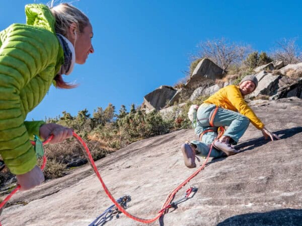 Woman belaying a climber
