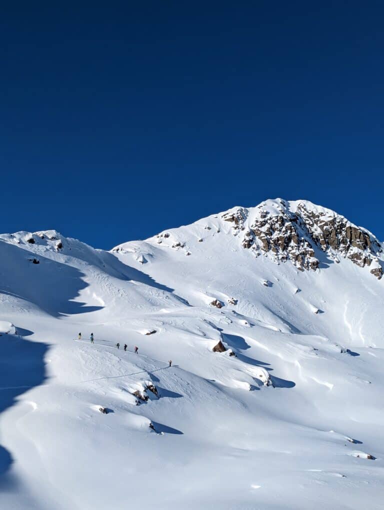 Ski tourers on the ascent behind Anermatt