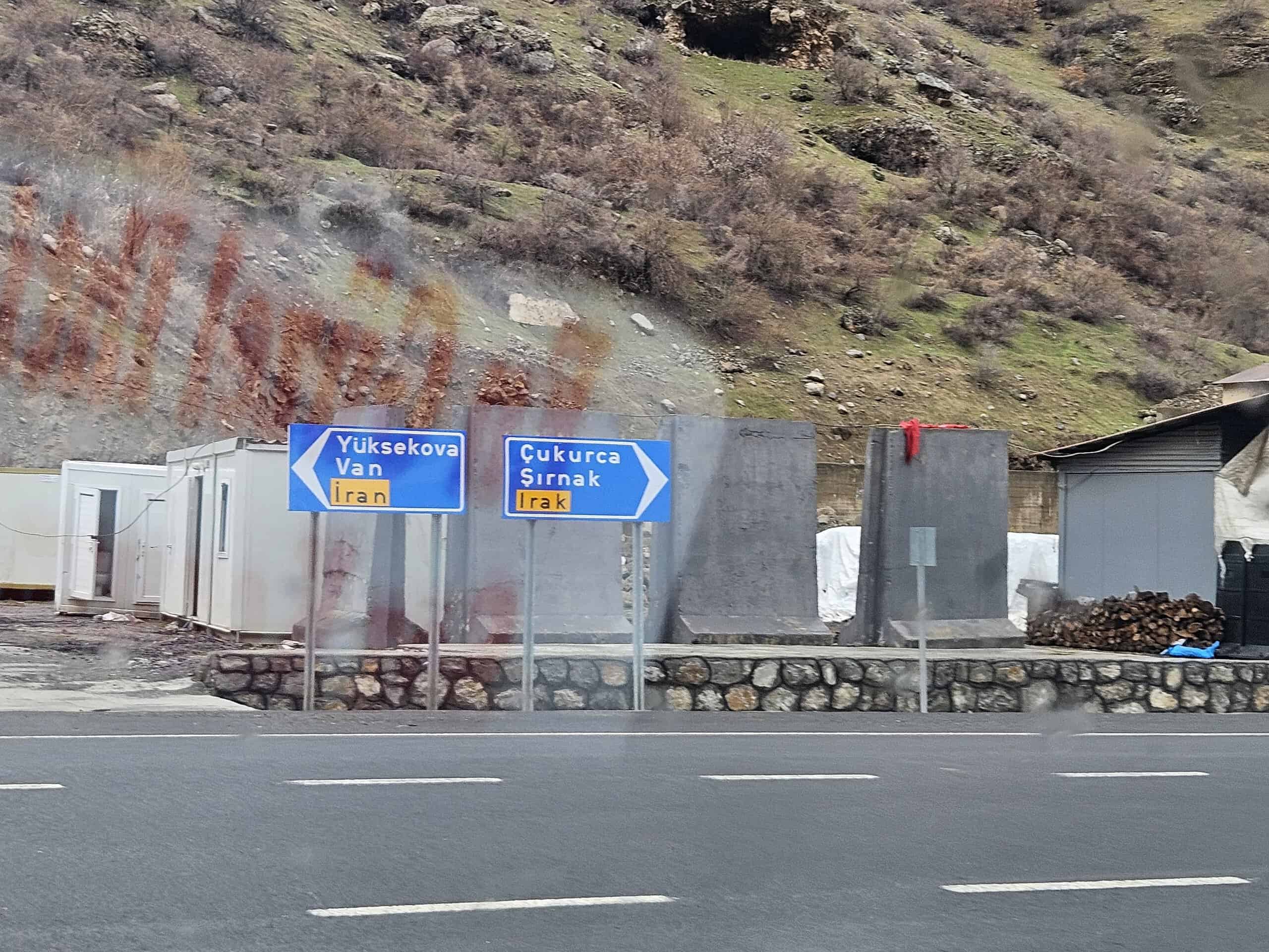 Road signs in the remote high mountains of Hakkâri, pointing towards Yüksekova, Van, Iran and Iraq, during a ski touring expedition in Turkey.